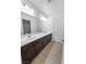 Bathroom featuring double sinks, modern fixtures, and wood-look flooring at 6537 Ditmars St, Las Vegas, NV 89166