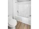 Bright bathroom featuring a white toilet, shower, and wood flooring at 6537 Ditmars St, Las Vegas, NV 89166