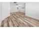 Bedroom with wood look floors and two windows for natural lighting at 6537 Ditmars St, Las Vegas, NV 89166
