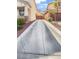 View down the long driveway to the two-story house and tan garage at 6537 Ditmars St, Las Vegas, NV 89166
