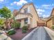 Charming two-story home with tan stucco exterior, landscaped yard, and attached garage at 6537 Ditmars St, Las Vegas, NV 89166