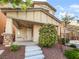 Inviting front entrance with stone accents, landscaped yard, and covered porch at 6537 Ditmars St, Las Vegas, NV 89166
