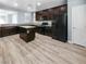 Well-lit kitchen with stainless steel appliances, dark cabinetry, and a central island at 6537 Ditmars St, Las Vegas, NV 89166