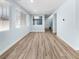 Spacious living area with wood-look floors, large windows, and neutral paint at 6537 Ditmars St, Las Vegas, NV 89166
