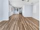 Open-concept living room with wood-look floors and large windows allowing for natural light at 6537 Ditmars St, Las Vegas, NV 89166