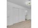 Bright, minimalist bedroom featuring a closet, and modern decor. Doorway access to bathroom at 6700 Pine Needle Ct, Las Vegas, NV 89108
