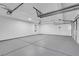 Spacious three-car garage with clean, painted walls and ceiling at 6700 Pine Needle Ct, Las Vegas, NV 89108