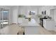 Stylish kitchen boasting white cabinets, marble countertops, and a large island with seating at 6700 Pine Needle Ct, Las Vegas, NV 89108