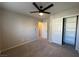 Bedroom featuring plush carpet, ceiling fan, and closet with shelves at 6777 Wormwood Ln, Las Vegas, NV 89148