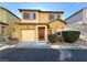 Two-story home featuring an attached garage, well-maintained landscaping, and warm curb appeal at 6777 Wormwood Ln, Las Vegas, NV 89148