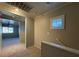 Hallway leading to a bright bedroom, featuring neutral paint and carpet at 6777 Wormwood Ln, Las Vegas, NV 89148
