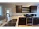 Bright kitchen boasts stainless appliances, wood cabinets, a large sink, and granite countertops at 6777 Wormwood Ln, Las Vegas, NV 89148