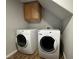 Laundry room featuring wood floors, washer and dryer, and cabinet storage at 6777 Wormwood Ln, Las Vegas, NV 89148