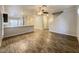 Open concept living and dining area with wood floors and contemporary design, open staircase at 6777 Wormwood Ln, Las Vegas, NV 89148