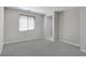 Bright bedroom with plush carpeting, window, and adjacent doorway at 701 Monroe Hill Pl, Henderson, NV 89011