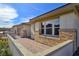 Side exterior view of home featuring stylish stone accents, brick paved patio, and well maintained landscaping at 701 Monroe Hill Pl, Henderson, NV 89011