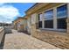 Modern home exterior with stone accents, brick pavers, and a gated driveway at 701 Monroe Hill Pl, Henderson, NV 89011