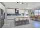 Elegant kitchen with sleek white cabinets, a center island with seating, and stainless steel appliances at 701 Monroe Hill Pl, Henderson, NV 89011