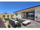 Virtually staged backyard patio with modern seating, BBQ grill, and artificial grass at 701 Monroe Hill Pl, Henderson, NV 89011