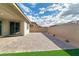 Spacious brick-paved patio with low-maintenance landscaping and stucco wall at 701 Monroe Hill Pl, Henderson, NV 89011