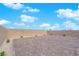 Paver backyard with privacy wall, artificial grass, and desert landscaping at 7128 Port Stephens St, North Las Vegas, NV 89084
