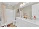 Bright bathroom features a double vanity, white cabinets, and a shower-tub combination at 7128 Port Stephens St, North Las Vegas, NV 89084