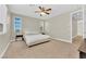 Bedroom with neutral walls and carpet features windows and a ceiling fan at 7128 Port Stephens St, North Las Vegas, NV 89084