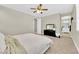 Bedroom with neutral walls and carpet features windows and a ceiling fan at 7128 Port Stephens St, North Las Vegas, NV 89084