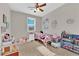 bedroom features a ceiling fan, window, and carpet at 7128 Port Stephens St, North Las Vegas, NV 89084