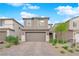 Charming two-story home featuring a brick driveway, neutral color palette and well-manicured landscaping at 7128 Port Stephens St, North Las Vegas, NV 89084