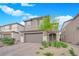Inviting two-story residence featuring a brick driveway, two-car garage and easy to maintain landscaping at 7128 Port Stephens St, North Las Vegas, NV 89084