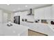 Modern kitchen with stainless steel appliances, quartz counters, white cabinets, and gas cooktop at 7128 Port Stephens St, North Las Vegas, NV 89084