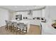 Modern kitchen with white cabinets, stainless steel appliances, and a large center island with seating at 7128 Port Stephens St, North Las Vegas, NV 89084