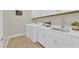 Bright laundry room with washer, dryer, sink, and white cabinetry at 7128 Port Stephens St, North Las Vegas, NV 89084