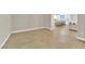 Open concept living space with wood-look tile flooring and light-colored walls at 7128 Port Stephens St, North Las Vegas, NV 89084