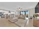 Open concept living space with sleek wood floors, modern furnishings and sliding door to backyard at 7128 Port Stephens St, North Las Vegas, NV 89084