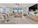 Comfortable living room featuring wood floors, large sectional and an open view to the kitchen at 7128 Port Stephens St, North Las Vegas, NV 89084