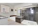 Bathroom featuring a marble shower, soaking tub, and neutral walls at 748 Dellenbaugh Ct, Las Vegas, NV 89178