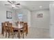 Bright dining room with a wooden table set for six and neutral walls at 748 Dellenbaugh Ct, Las Vegas, NV 89178