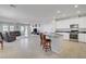 Open concept kitchen island with barstool seating connecting to the living area at 748 Dellenbaugh Ct, Las Vegas, NV 89178