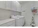 Laundry Room with white cabinets, front loading washer and dryer, with neutral walls at 748 Dellenbaugh Ct, Las Vegas, NV 89178