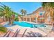 A backyard featuring a luxurious pool, spa, and plenty of space for outdoor living at 7751 Locke Haven Dr, Las Vegas, NV 89123