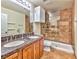 Well-lit bathroom featuring a double vanity, and tiled shower at 7751 Locke Haven Dr, Las Vegas, NV 89123