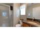 Cozy bathroom featuring granite countertops, wood cabinetry, and a glass enclosed shower at 7751 Locke Haven Dr, Las Vegas, NV 89123