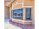 Close up of home exterior featuring a large window and manicured landscaping at 7751 Locke Haven Dr, Las Vegas, NV 89123