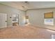 Spacious living room with carpet, neutral walls, and windows at 7751 Locke Haven Dr, Las Vegas, NV 89123