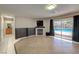 Cozy living area with a fireplace, and sliding door access to a pool at 7751 Locke Haven Dr, Las Vegas, NV 89123