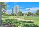 Scenic golf course view showcasing sand traps, mature trees and the iconic city skyline in the distance at 778 Oakmont Ave # 312, Las Vegas, NV 89109