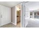 Bright hallway with tile flooring and entryways to the bathroom, front door, and main living area at 778 Oakmont Ave # 312, Las Vegas, NV 89109