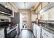 Modern kitchen with stainless steel appliances, granite countertops, and sleek black tile flooring at 778 Oakmont Ave # 312, Las Vegas, NV 89109
